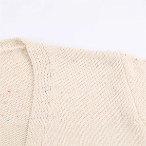 Close-up of confetti knit texture on a soft V-neck sweater with multicolored specks