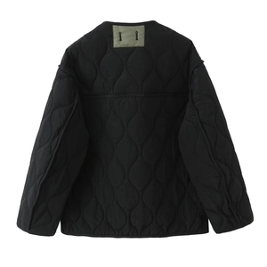 Detail of onion quilted jacket liner with contrast olive green collar block and stitching
