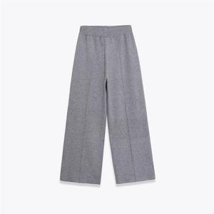 Detail of grey wide-leg knit trousers with high elastic waist and vertical center seam