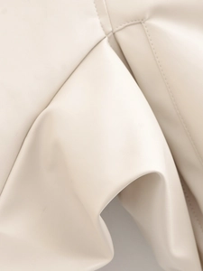 Detail of premium cream PU leather jacket showing fine stitching and smooth texture