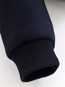 Close-up of ribbed elastic cuffs on a navy blue long-sleeve winter jacket for women