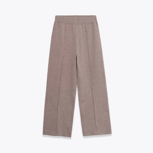 Flat lay of taupe wide-leg knit pants featuring a high waist and central pleat details