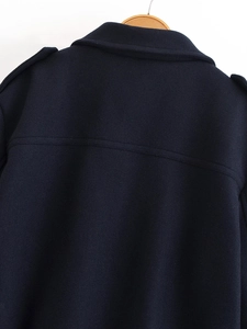 Detail of dark blue wool jacket back featuring shoulder epaulettes and premium stitching