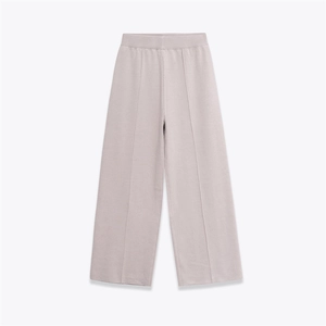 Detailed texture of high-waist knit wide-leg pants with elegant vertical seam stitching