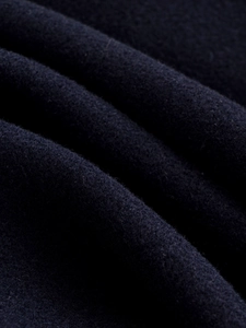 Detailed close-up showing the soft navy blue wool fabric texture of the jacket