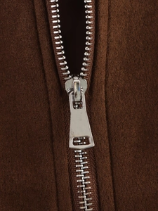 Macro shot of high-quality silver metal zipper on dark brown suede textured jacket