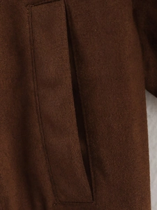 Close-up detail of smooth pocket stitching and premium suede texture on brown jacket