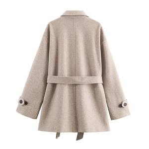 Back view of light oatmeal wool coat with waist belt and decorative cuff straps