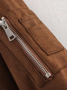 Detail of premium brown suede jacket featuring a high-quality silver metal zipper and stitching