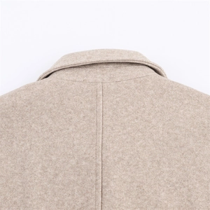Macro detail of high-quality cashmere coat collar showing precise stitching and fiber texture