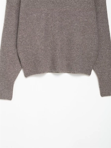 Detail of ribbed knit cuffs and hem on a soft brown wool blend sweater for women
