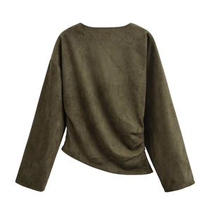 Detail showing the pleated waist and soft suede texture of the asymmetrical women's top