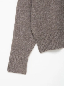 Detail of mocha brown knit sweater showing fine texture and ribbed cuff stitching