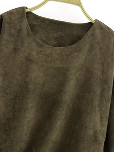 Detail of olive green faux suede T-shirt showing round neckline and premium texture