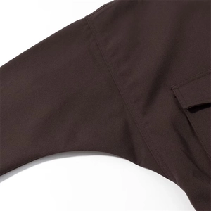 Deep brown women's casual zip jacket showing shoulder seams and pocket detail closeup