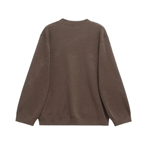 Close-up of dark brown knitted cardigan showing ribbed cuffs and neck collar detail