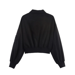 Women's black cropped faux suede jacket with puff sleeves and ribbed cuffs back view