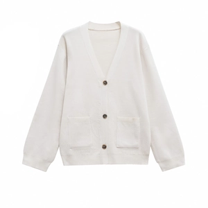 Close-up of knit texture with V-neckline, brown buttons, and front pockets on beige cardigan