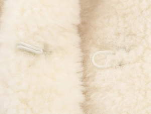 Macro detail of plush faux fur texture and invisible loop fastening on winter coat