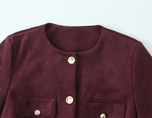 Detail view of burgundy suede jacket with golden buttons and flap pockets