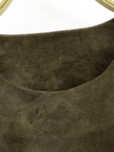 Detailed macro view of high-quality dark olive green suede fabric texture on t-shirt collar