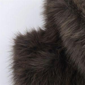Close-up of deep brown plush faux fur fabric showing dense and silky texture details