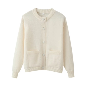 Macro detail of creamy white knit cardigan with round neck and five matching buttons