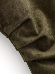 Detailed macro shot of dark olive green faux suede fabric with elegant pleated texture