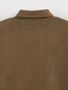 Detail shot of brown faux suede shirt collar and shoulder stitching on jacket