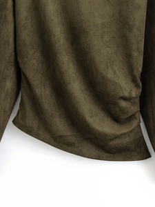 Close-up of olive green faux suede fabric with elegant side ruching and soft texture
