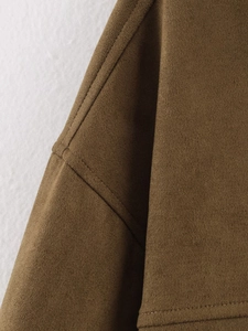 Detailed close-up of brown faux suede jacket showing fine stitching and soft texture