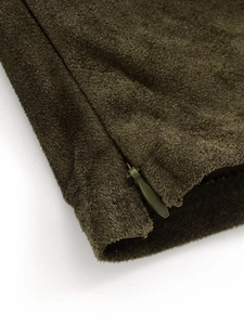 Detail view of olive green faux suede fabric with hidden zipper and fine texture