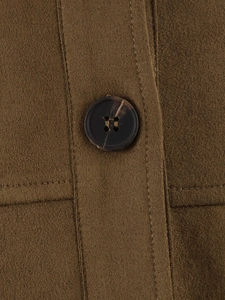 Detailed macro view of high-quality brown suede fabric and marble pattern button