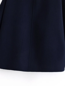 Close-up of navy wool jacket hem showing precise stitching and fabric texture