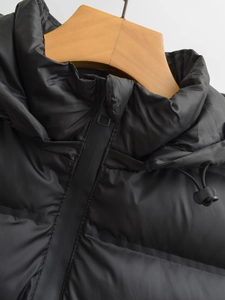 Gros plan d'un gilet coupe-vent noir avec col montant et cordons de serrage réglables