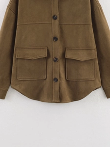 Detailed view of the tan suede jacket fabric texture with flap pockets and buttons