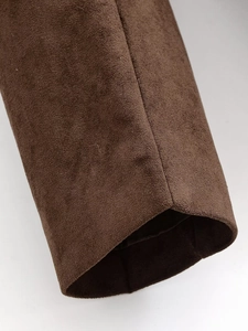 Macro shot of brown suede jacket cuff highlighting fine texture and detailed stitching