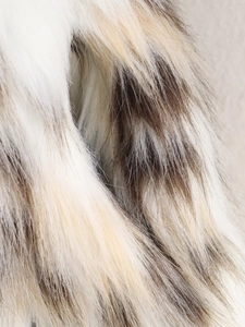 Detailed macro view of the soft faux fur fabric texture showing hair layers and color gradient
