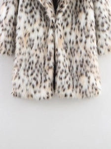 Detail of faux fur coat featuring fluffy texture and brown leopard print pattern