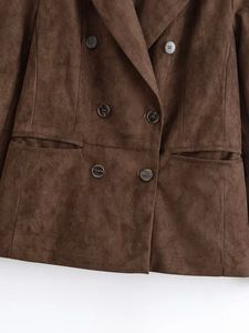 Detail of dark brown double-breasted suede blazer with six buttons and flap pockets