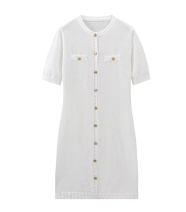 Close-up of white knitted dress featuring gold buttons and decorative pockets texture
