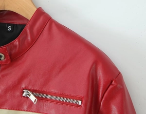 Detail of red PU leather jacket featuring a stand collar with snap button and metal zipper