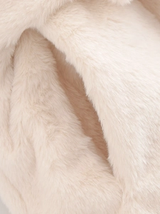 Close-up macro of soft off-white faux fur texture showing plush and warm material fibers