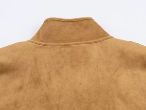 Detailed close-up of the stand-up collar and premium camel suede texture on the jacket