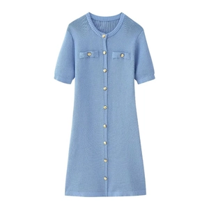Close-up of light blue knit dress with vertical texture and gold button details
