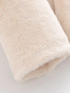 Close-up detail of soft faux fur fabric texture on a cream-colored winter coat