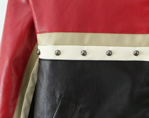Detail of color-block PU leather jacket featuring metallic round rivets and stitching