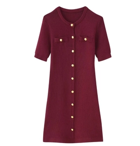 Detail of burgundy short sleeve knit dress featuring polished gold metal buttons