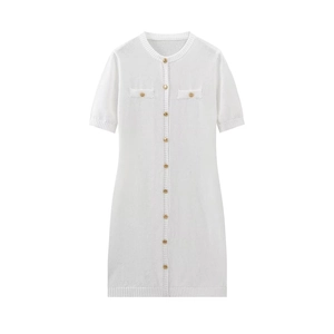 Close-up of white knit dress featuring gold metal buttons and detailed ribbed edges