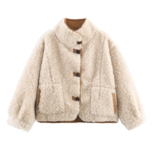 Detail of warm beige sherpa fleece jacket with contrasting brown faux suede trim